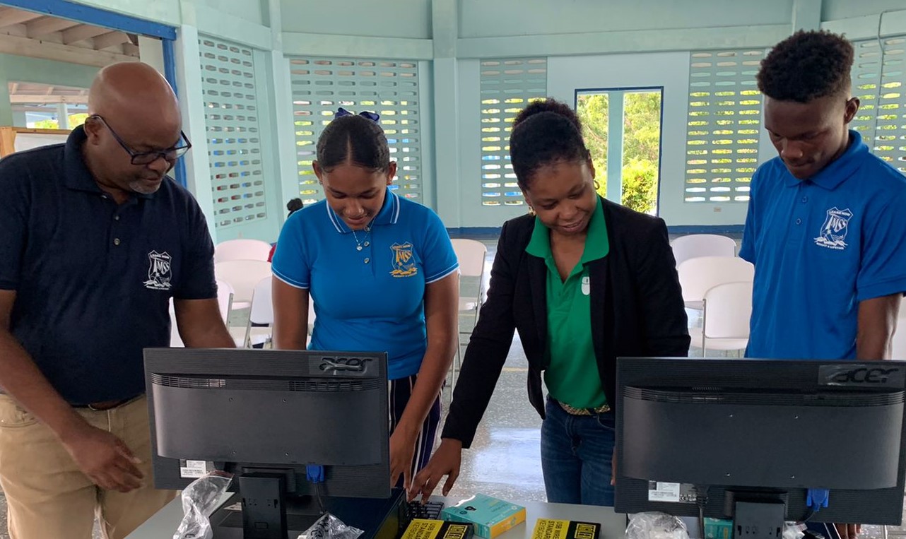 Students and volunteers setting up donated computers at a community workshop
